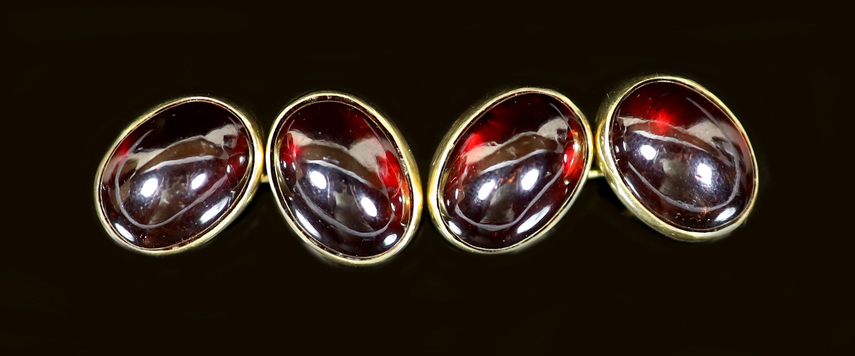 A pair of early 1960's 18ct gold and cabochon garnet set oval cufflinks